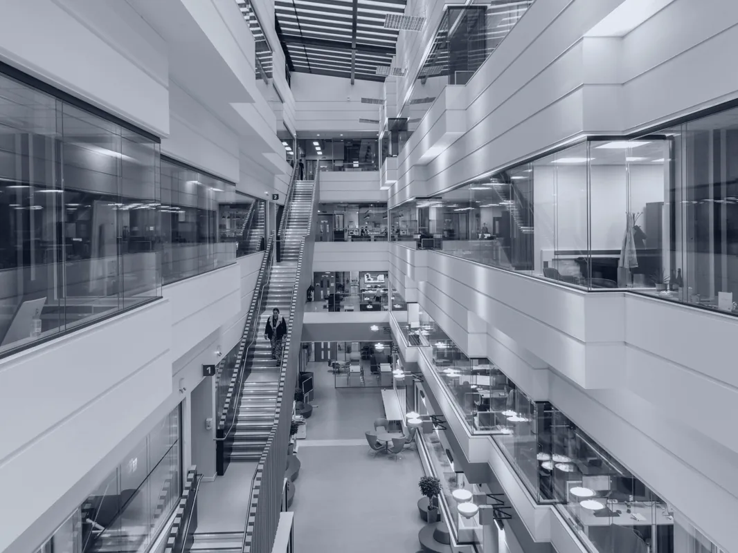 The atrium of the Materials Innovation Factory, with a long staircase rising between open floors of laboratories and meeting spaces.